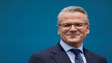 A large Maersk container ship docked at an Indian port.