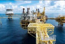 An offshore oil platform stands prominently at sea, emblematic of energy infrastructure.