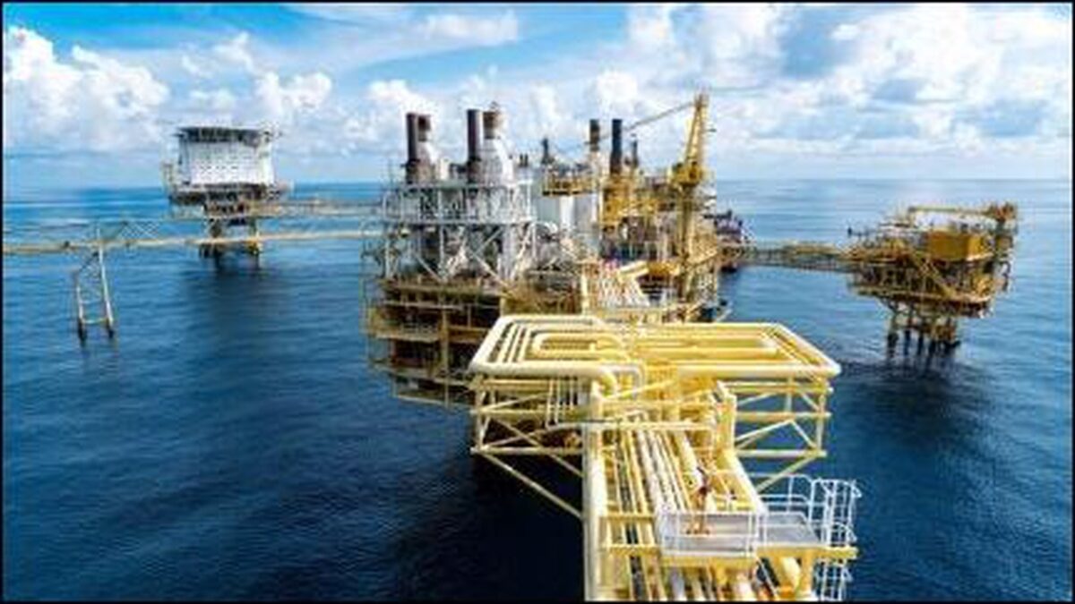 An offshore oil platform stands prominently at sea, emblematic of energy infrastructure.