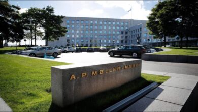 A large blue Maersk container ship sails on the ocean.