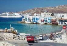 A large cruise ship at anchor off Mykonos, Greece, supporting the tourism industry.