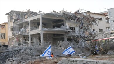 An Israeli air defense system intercepts incoming projectiles over a city.