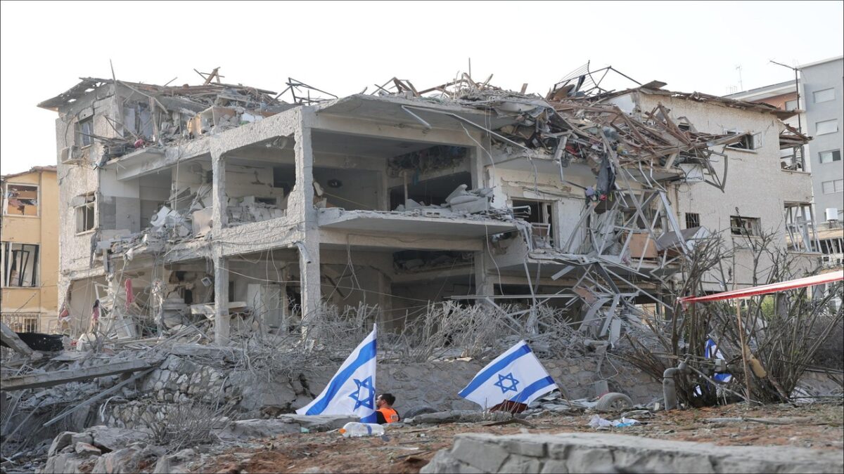An Israeli air defense system intercepts incoming projectiles over a city.