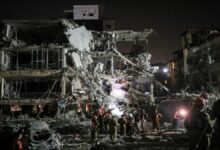 A large container ship sails on water, representing maritime shipping and global trade risks.