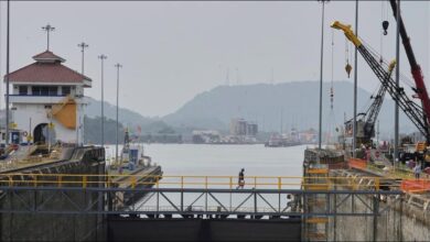 A container ship navigates through the Panama Canal, crucial for global shipping.