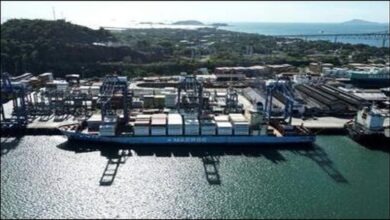 A large container ship navigates a Panama Canal lock, central to global logistics.