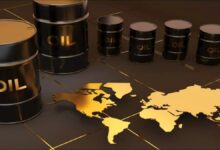 An expansive industrial oil refinery with multiple processing towers and interconnected pipelines at dawn.