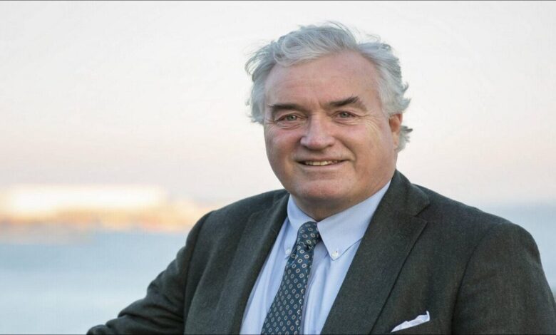 An LPG carrier ship with distinctive dome-shaped tanks sails on the ocean.