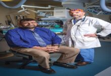 A quiet residential street with homes and parked cars in a Savannah neighborhood.