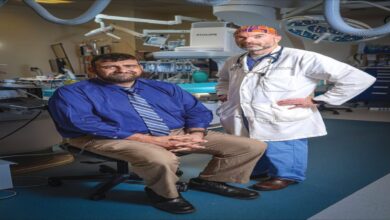 A quiet residential street with homes and parked cars in a Savannah neighborhood.