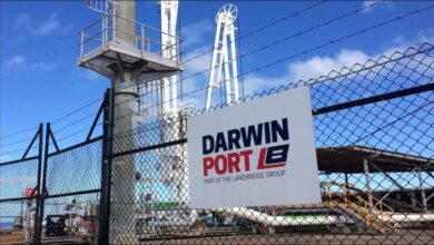 View of Australia's Port of Darwin with cargo ships and port infrastructure.