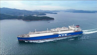 A modern NYK dual-fuel LNG carrier sailing on calm waters.