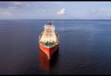 A large crude oil tanker sails on the open sea, representing global oil transport.