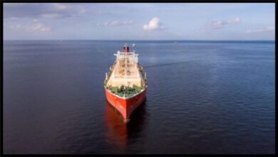 A large crude oil tanker sails on the open sea, representing global oil transport.