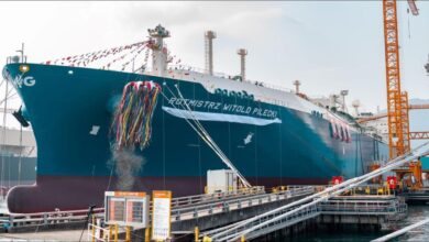A large ORLEN LNG carrier with spherical tanks transports natural gas at sea.
