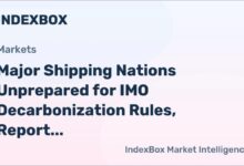 A large container ship moves across the ocean, laden with cargo containers.