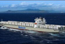 A Matson container ship with its distinctive red 'M' logo sails on the ocean.