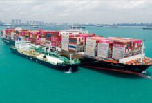 Oman's Marsa LNG bunkering facility with large white storage tanks.