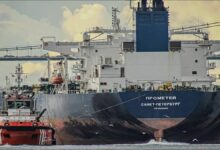 A large suezmax oil tanker sailing on calm open waters.