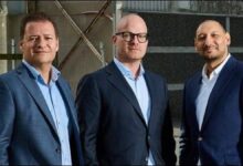 The bow of a large oil tanker cutting through waves on the open sea.