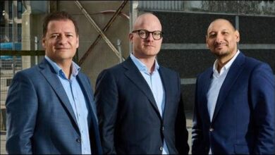 The bow of a large oil tanker cutting through waves on the open sea.