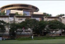 Bunkering vessel supplying marine fuel to a large cargo ship at sea.