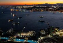A large crude oil supertanker sails on the ocean, symbolizing global transport.