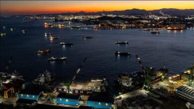 A large crude oil supertanker sails on the ocean, symbolizing global transport.