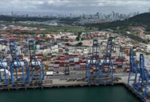 A large container ship sails through the locks of the Panama Canal.