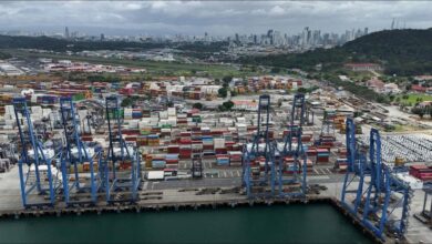 A large container ship sails through the locks of the Panama Canal.