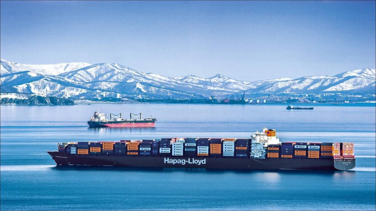Hapag-Lloyd's Hanover Express container ship sails loaded with cargo containers at port.