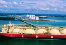 A large liquefied natural gas (LNG) carrier sails on the open sea.