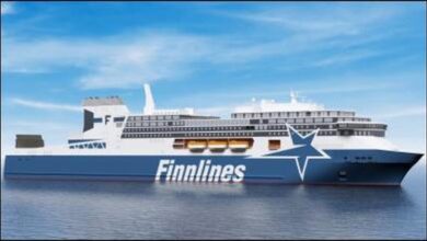 A large Finnlines ro-pax ferry, carrying cargo and passengers, sails on the sea.
