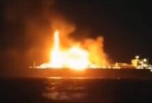 Russian LNG carrier Arctic Metagaz ablaze at sea, emitting smoke.