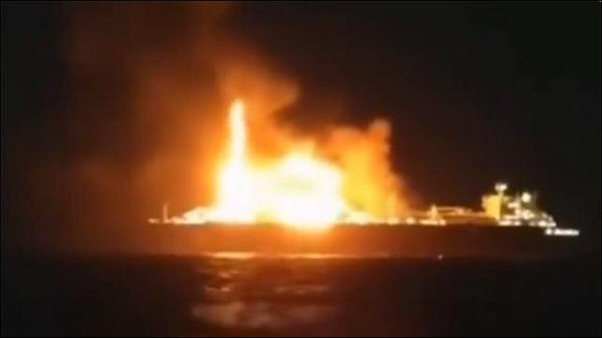 Russian LNG carrier Arctic Metagaz ablaze at sea, emitting smoke.