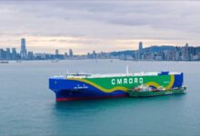 A large container ship undergoes green methanol bunkering in Hong Kong's busy port.
