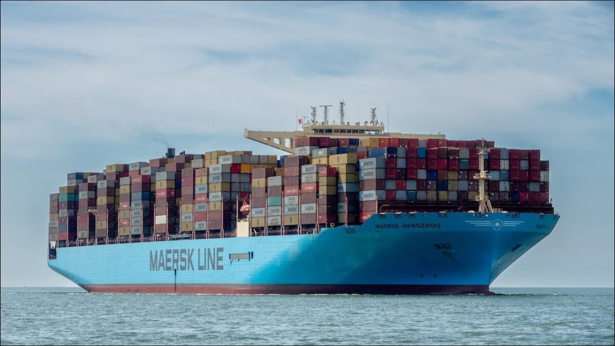 A large Maersk container ship, MAERSK EINDHOVEN, sails on the sea.