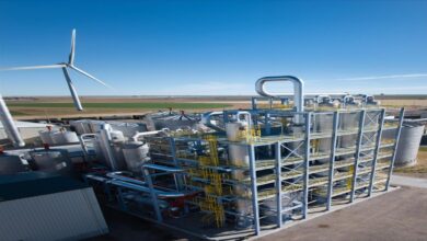 A large container ship sails on the open ocean, symbolizing the maritime energy transition.