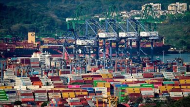 A large container ship transits the Panama Canal, central to the port operations dispute.