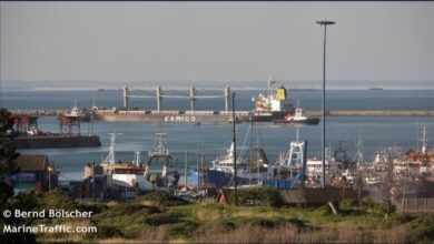 ElbOil bunker barge refueling a large tanker ship in port.