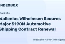 A large car carrier ship navigates the open ocean.