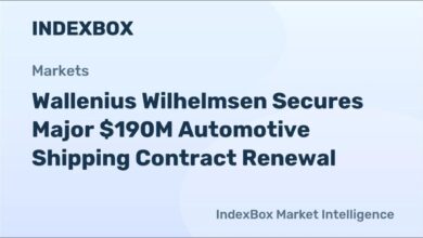 A large car carrier ship navigates the open ocean.