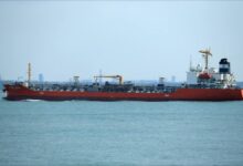 A massive VLCC tanker sails across the open ocean.