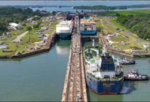 A large cargo vessel transits the Panama Canal, reflecting high shipping demand.