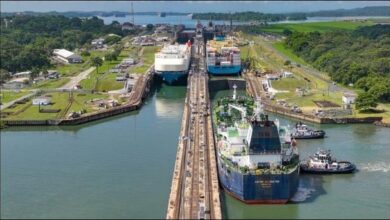 A large cargo vessel transits the Panama Canal, reflecting high shipping demand.
