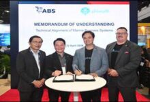 Three executives shake hands at Singapore Maritime Week for a new marine biofuel partnership.