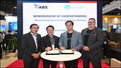 Three executives shake hands at Singapore Maritime Week for a new marine biofuel partnership.