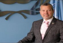 A large cargo ship sails through a narrow strait, representing vessels using routes like Hormuz.