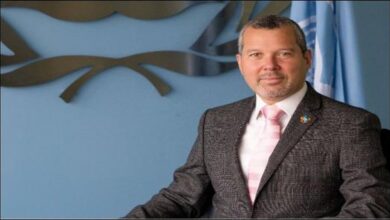 A large cargo ship sails through a narrow strait, representing vessels using routes like Hormuz.