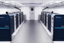 A large container ship named Helenus sails on calm blue waters, symbolizing maritime shipping.